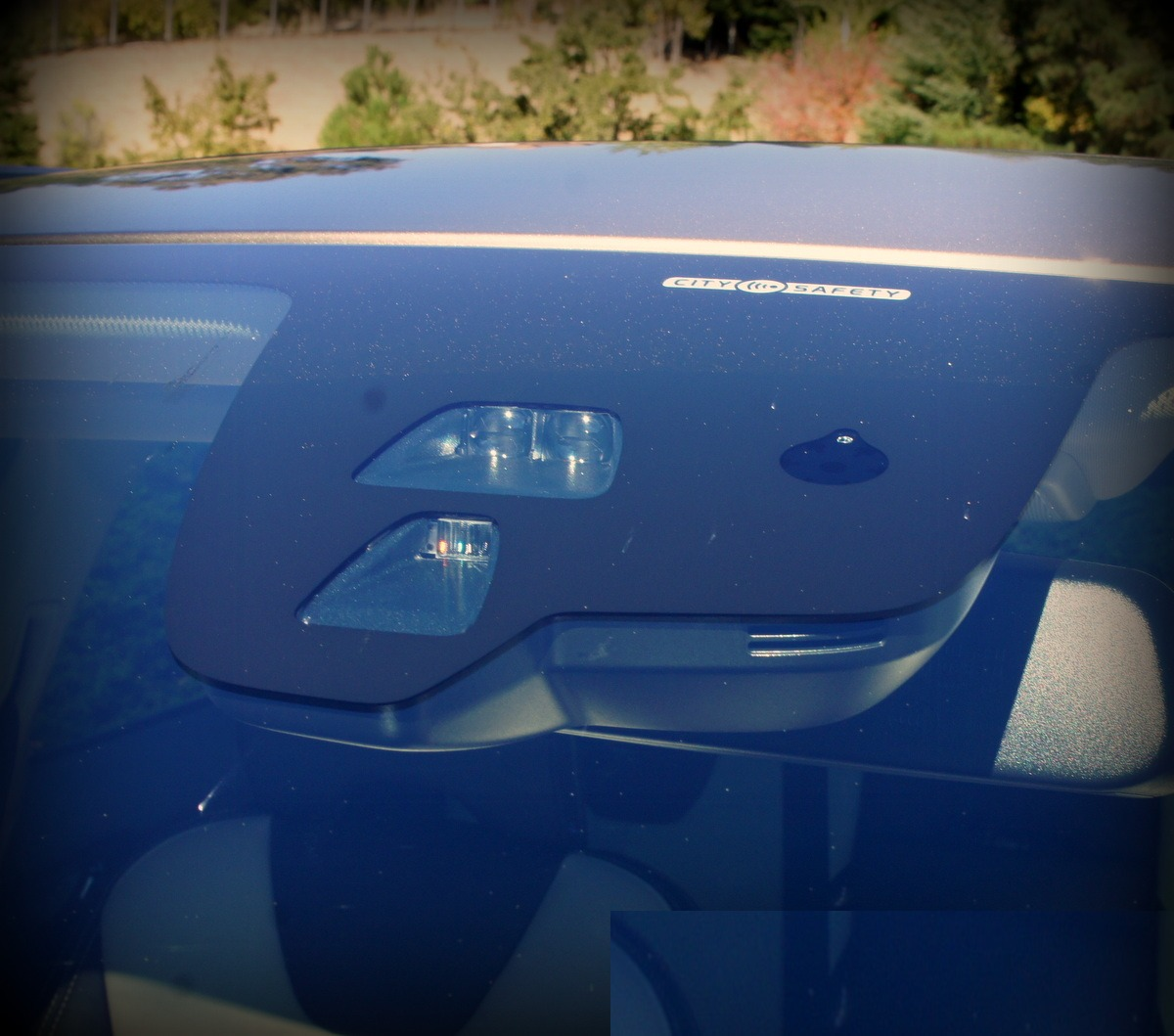 Factory windscreen ADAS camera housing viewed from outside the glass
